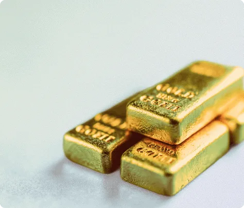 Shiny gold bullion bars stacked together, symbolizing wealth and investment.