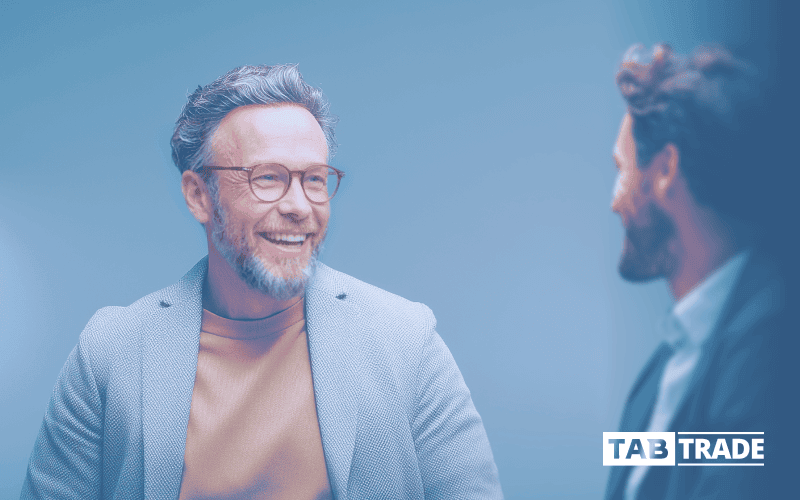 Friendly business professionals discussing finance at TABTRADE platform, showcasing trading and investment services.